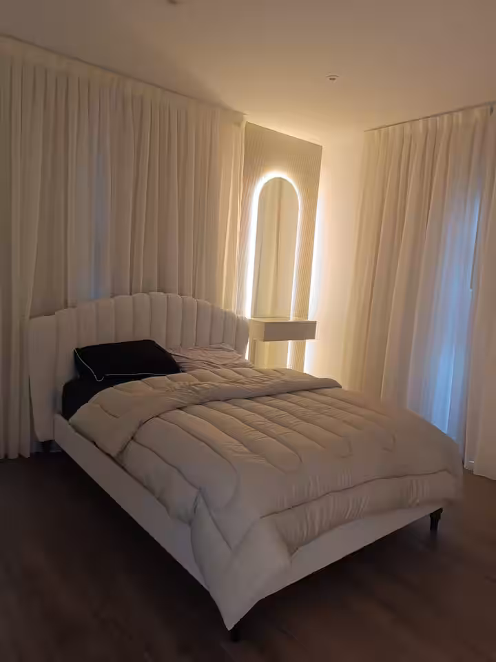 Master bedroom with king bed and cove lighting