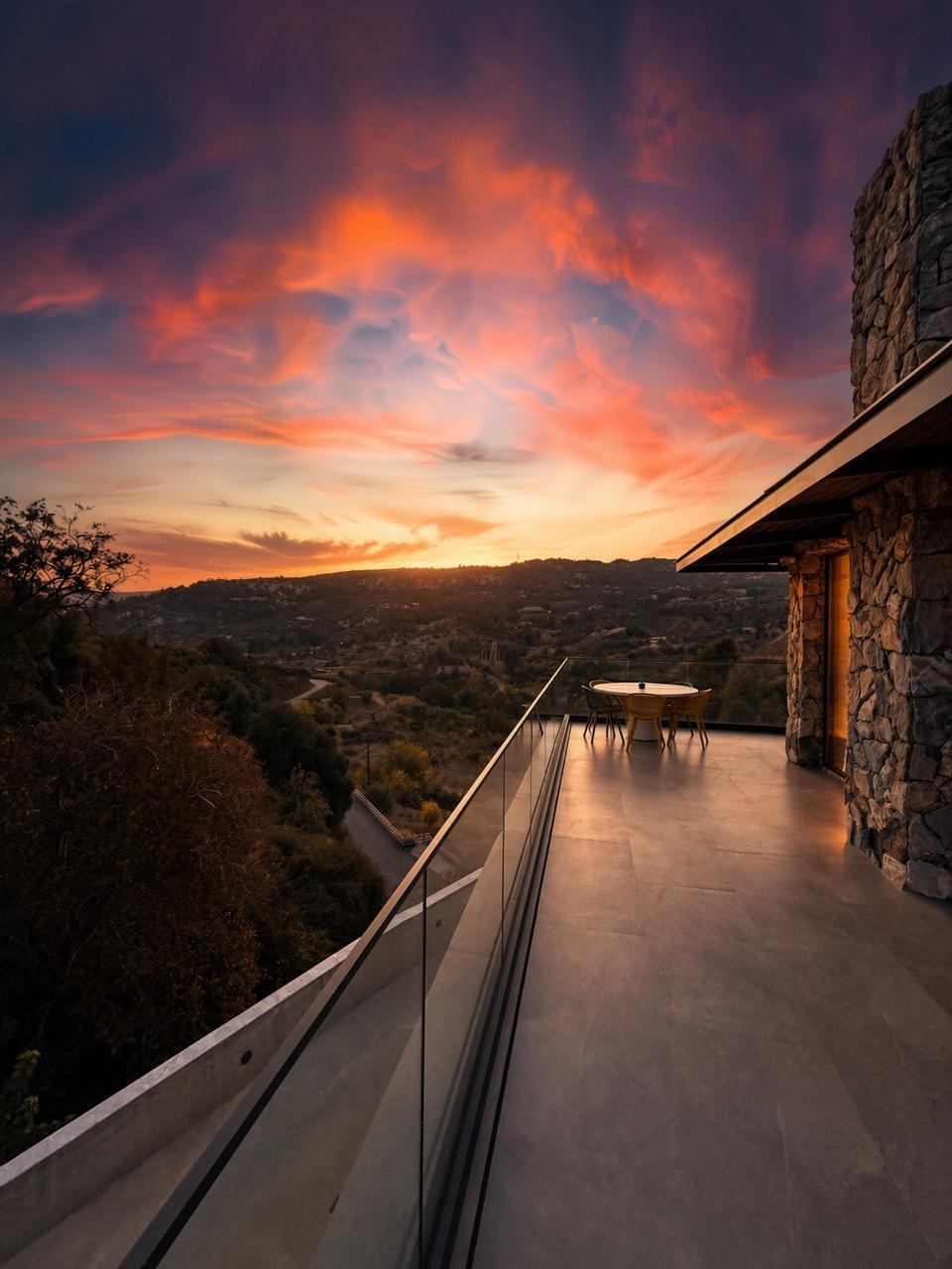 Terrace dining table at sunset above the valley